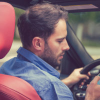 Guy texting while driving.jpg.crdownload Guy texting while driving.jpg.crdownload