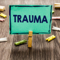 Green sign that reads trauma - to highlight that traumatic injury can result in conditions such as Complex Regional Pain Syndrome (CPRS) Green sign that reads trauma - to highlight that traumatic injury can result in conditions such as Complex Regional Pain Syndrome (CPRS)
